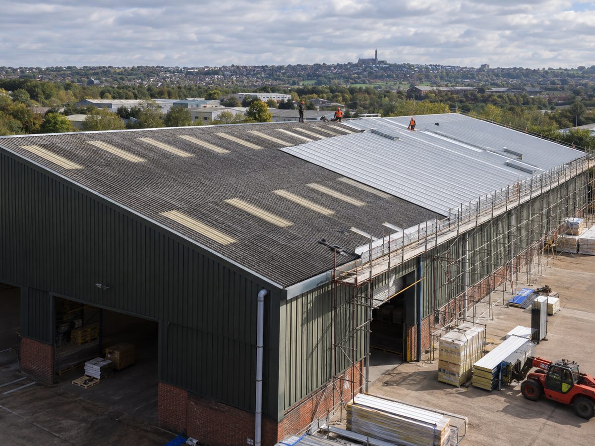 Overclad in progress on a steel-framed warehouse roof
